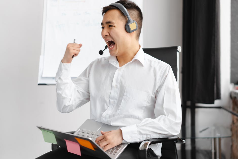 Man in White Dress Shirt Wearing Headphones